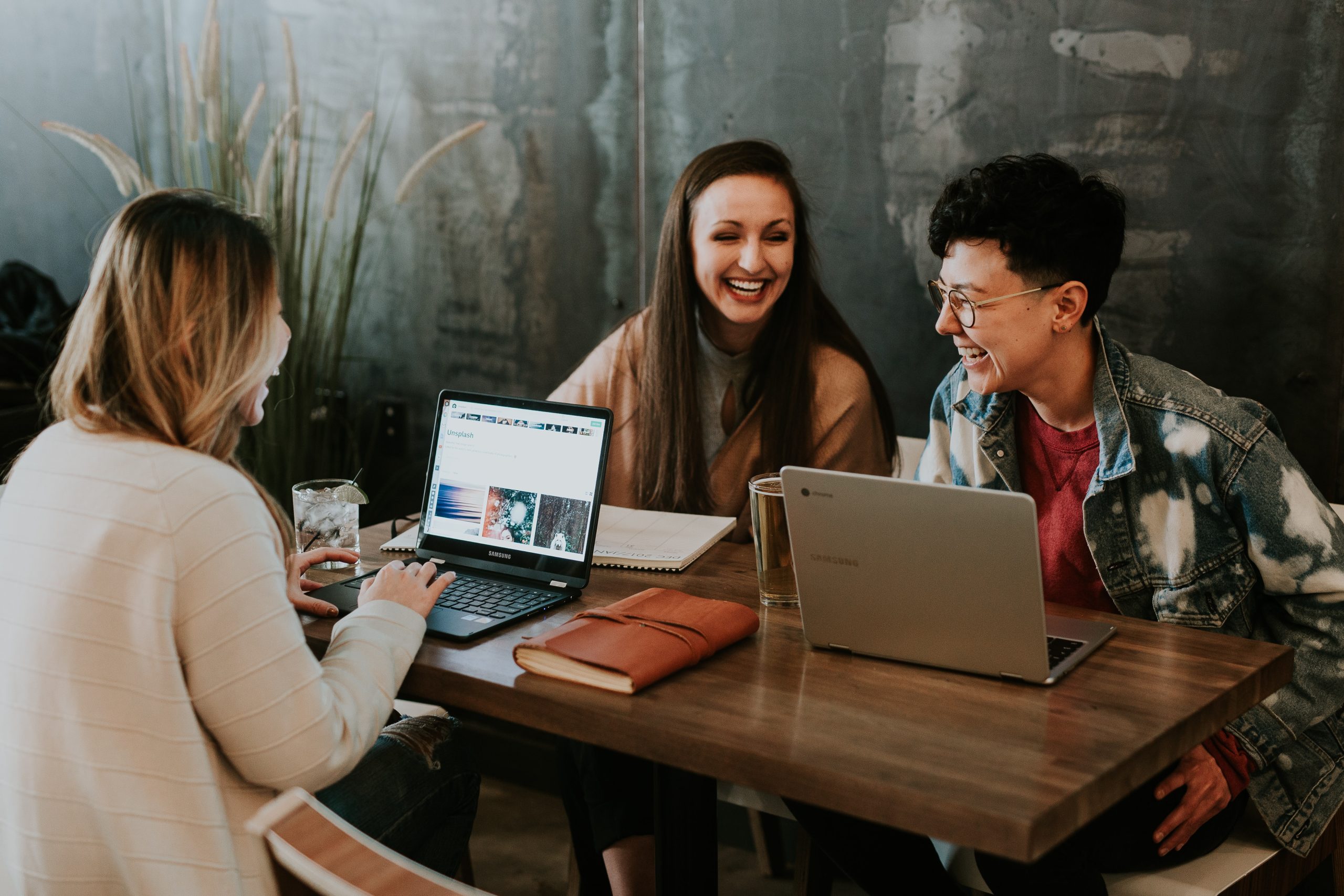 young workers at table with laptops - Gen-Z Sustainability