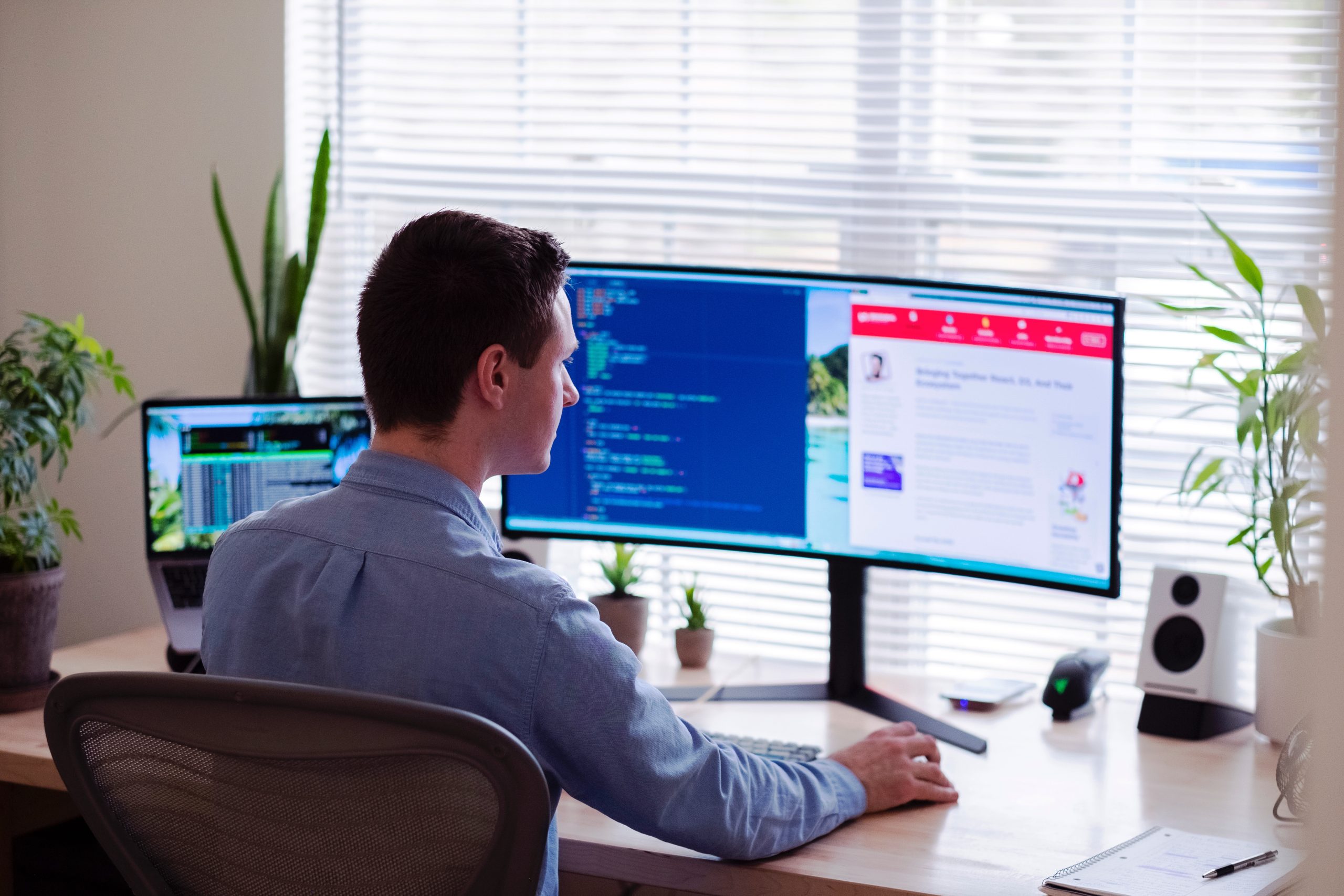 remote worker at desk with multiple screens - IT Asset Management
