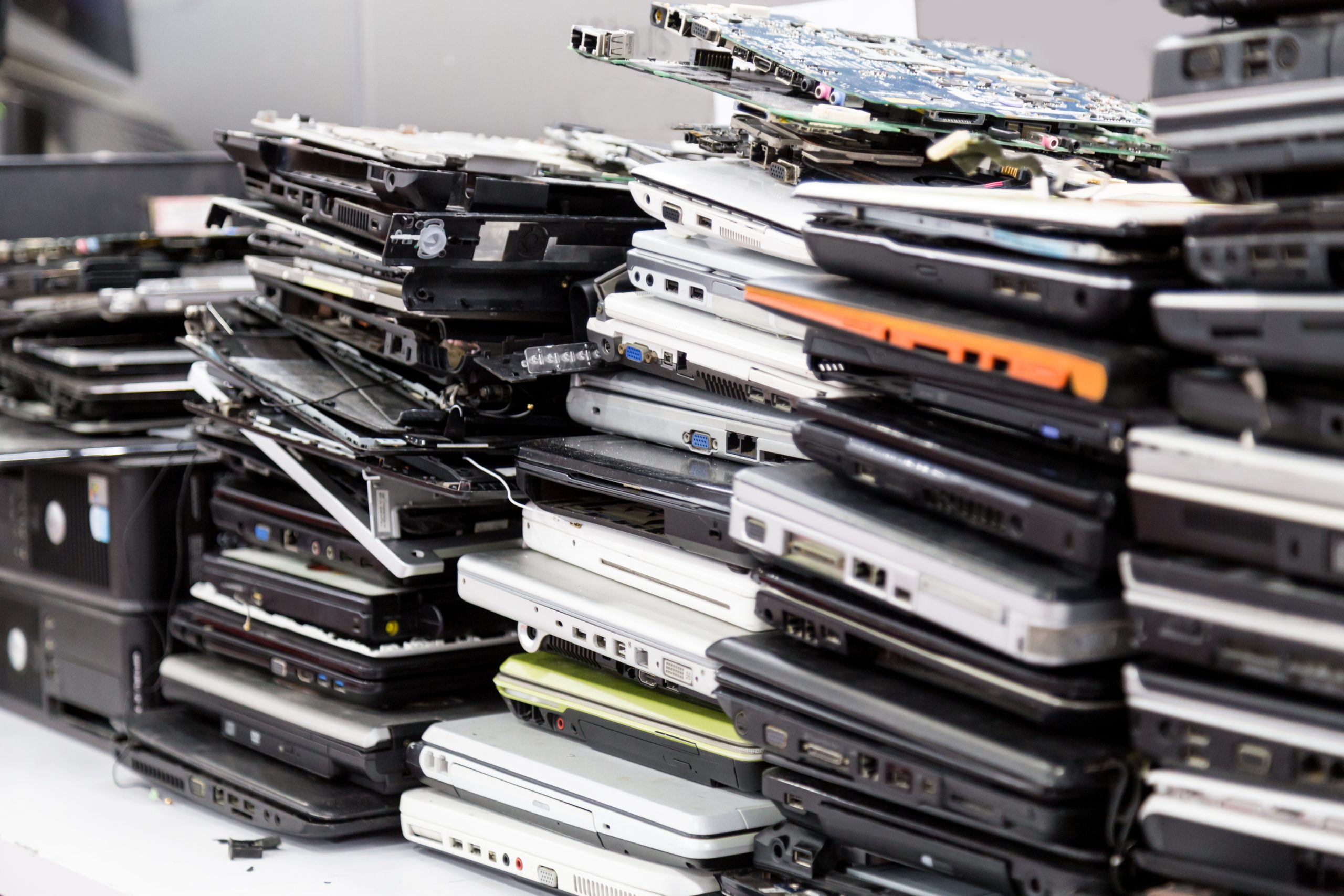 stacks of laptops - IT e-waste